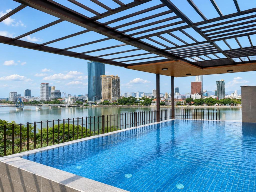 a swimming pool with a view of a city skyline at Ngoc Thuong Hotel & Apartment- Han River View in Danang