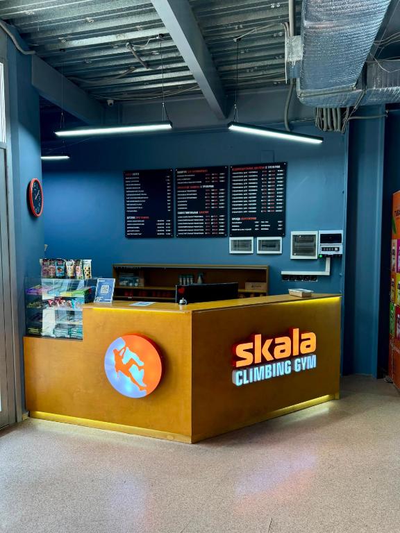 a sushi counter in a room with a blue wall at Skala Hostel in Almaty