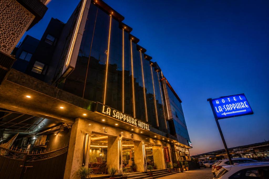 a building with a sign on the side of it at Airport La Sapphire Hotel & Restaurant in New Delhi