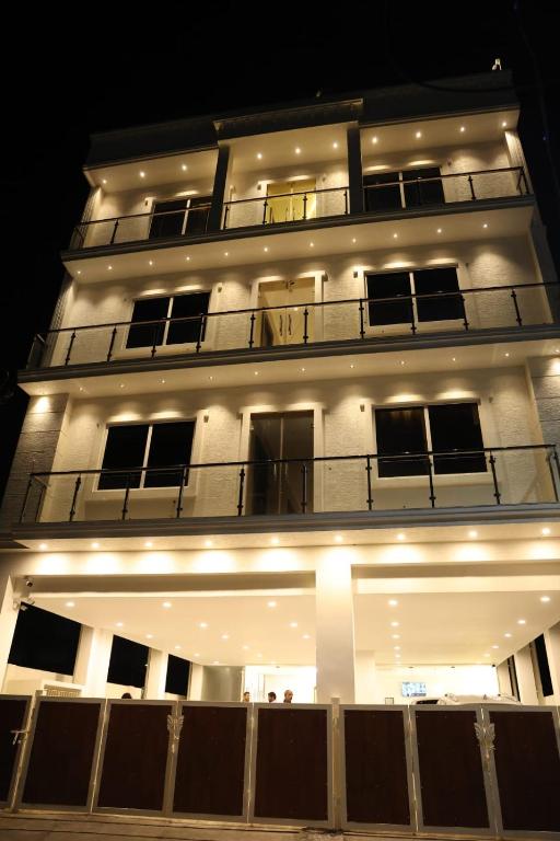 a large white building with a balcony at night at Kings Residency in Chennai