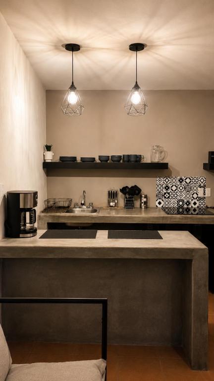 a kitchen with a sink and a counter top at Oros Jalatlaco in Oaxaca City