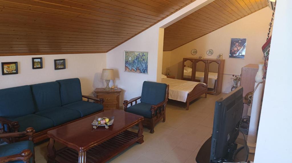 a living room with a couch and a bed at VILLA PEPETO Durres Albania in Durrës
