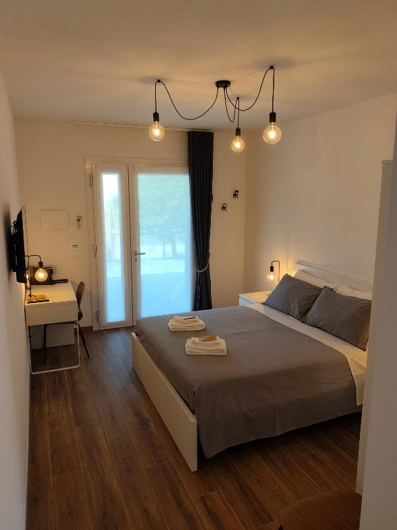 a bedroom with a bed with two towels on it at PiaveHome in San Donà di Piave