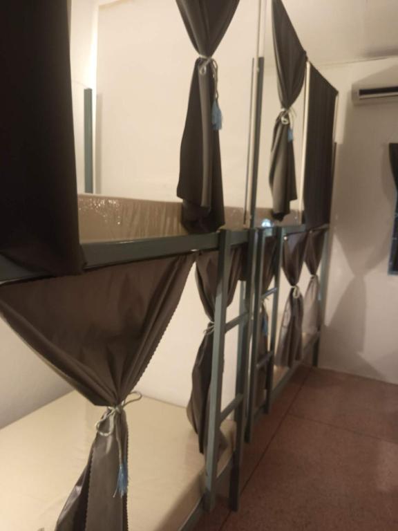 a row of umbrellas hanging on a wall at Urban Nest Hostel in Bangkok