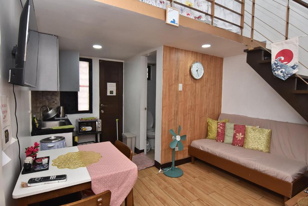 a living room with a couch and a table at Apartment MJ in Olongapo