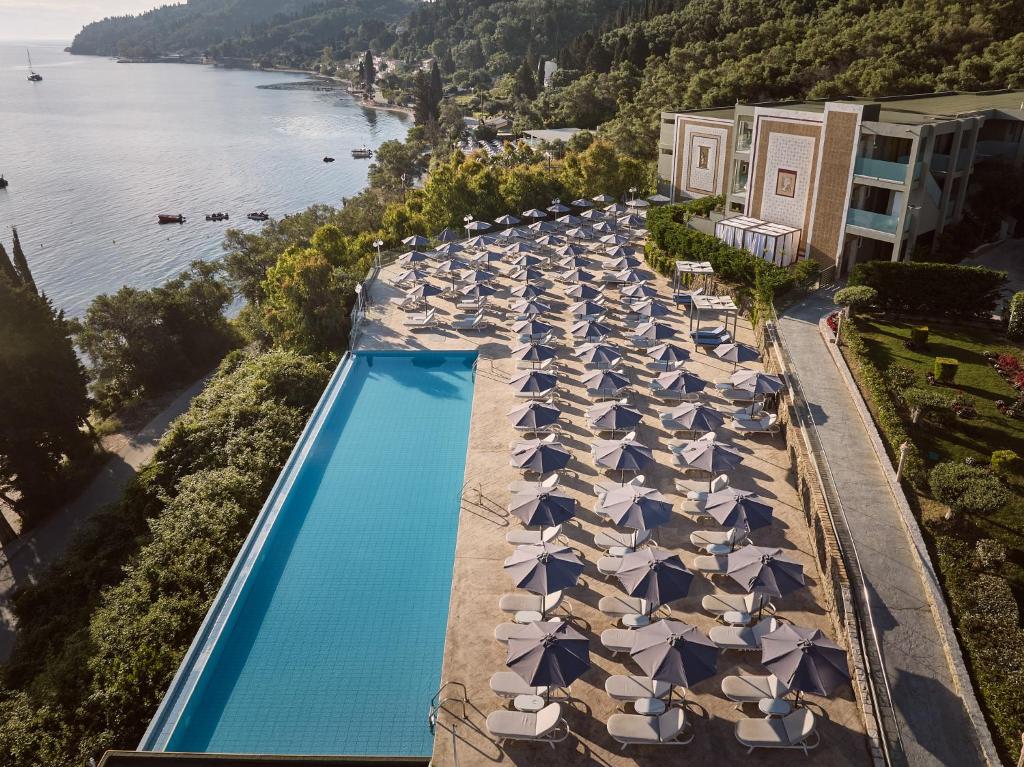 an overhead view of a swimming pool with umbrellas at Mythos Palace Resort - Adults Only in Boukari