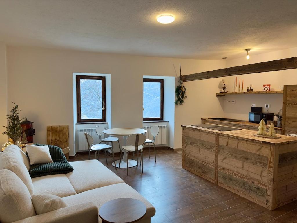 a living room with a couch and a table at Maison BelleVue in Châtillon