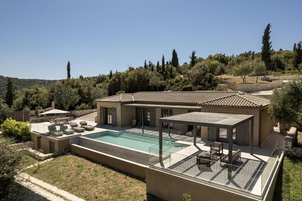 a house with a swimming pool in a yard at Villa Ouranos by Villa Select in Fiskardo