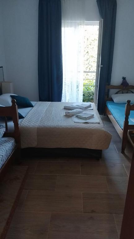 a bedroom with two beds and a window at Nada Rooms in Budva