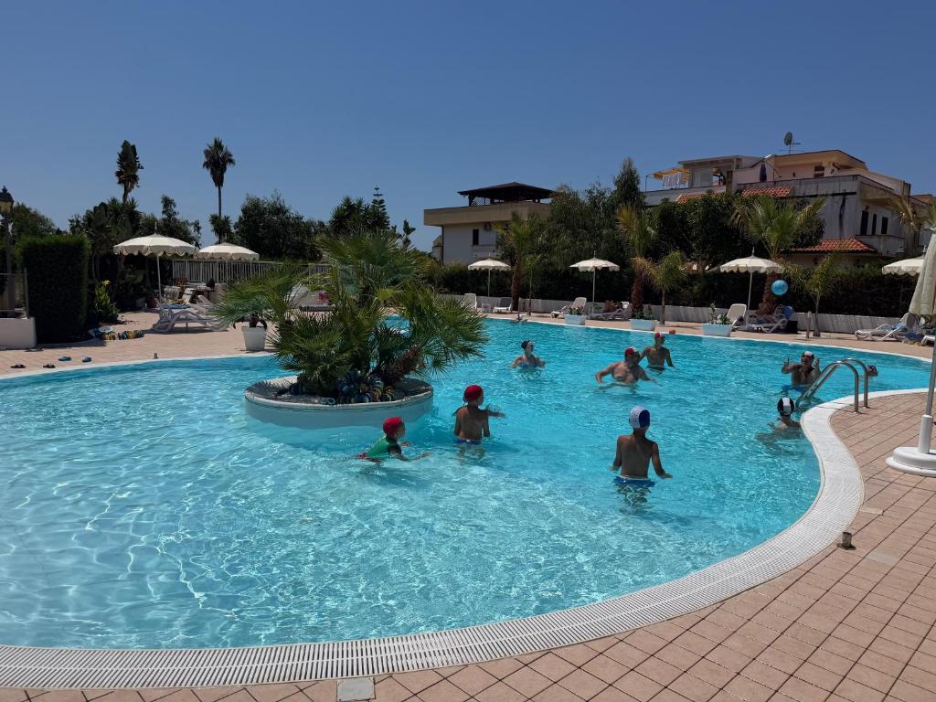 a group of people playing in a swimming pool at La Casa Serena in Scalea