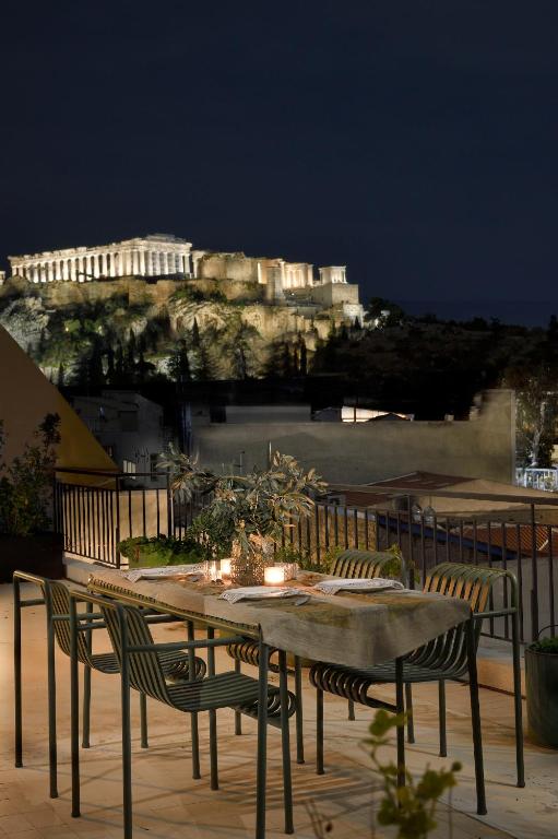 a table and chairs with a view of a castle at AIONION RESIDENCES by K&K in Athens