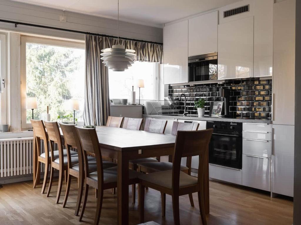 a kitchen with a dining room table and chairs at 2-Story Condo with Terrace in Åre