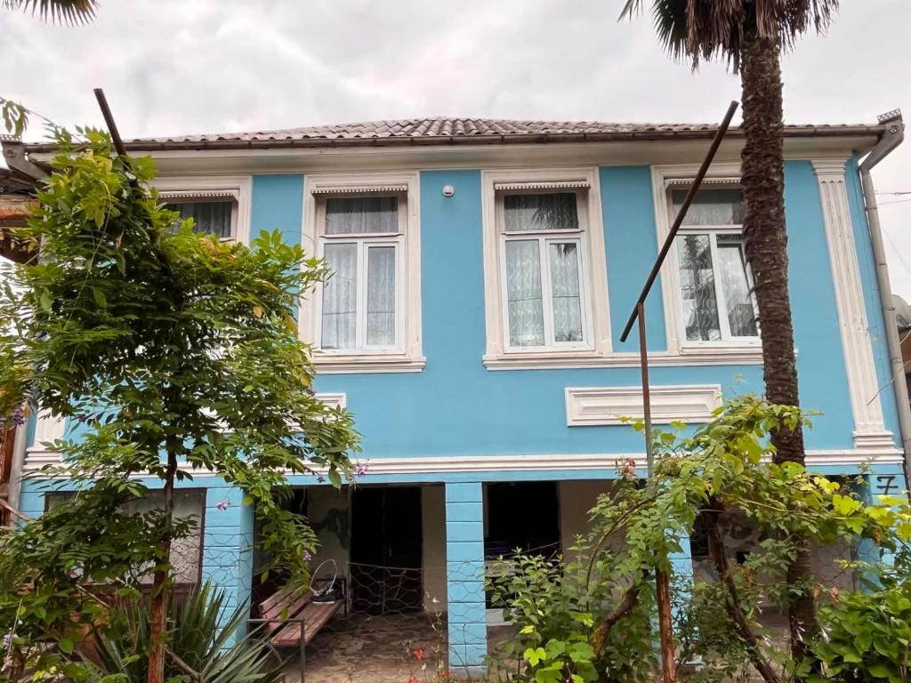 a blue house with trees in front of it at Guramishvili 5 in Kobuleti
