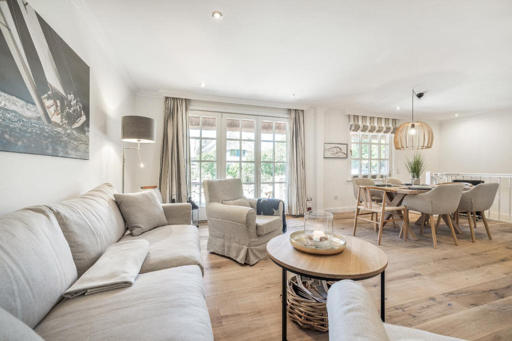 a living room with a couch and a table at Düne in Keitum