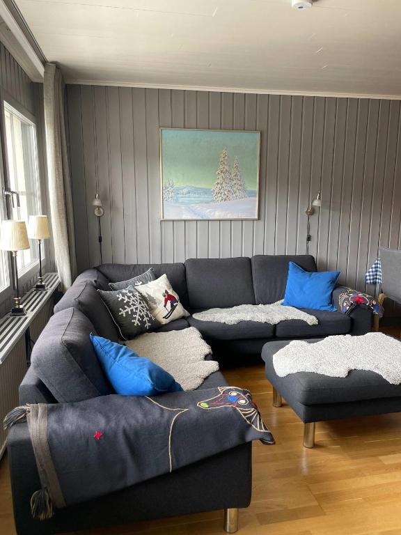 a living room with a couch and blue pillows at Central Apartment with Sauna & Balcony in Åre
