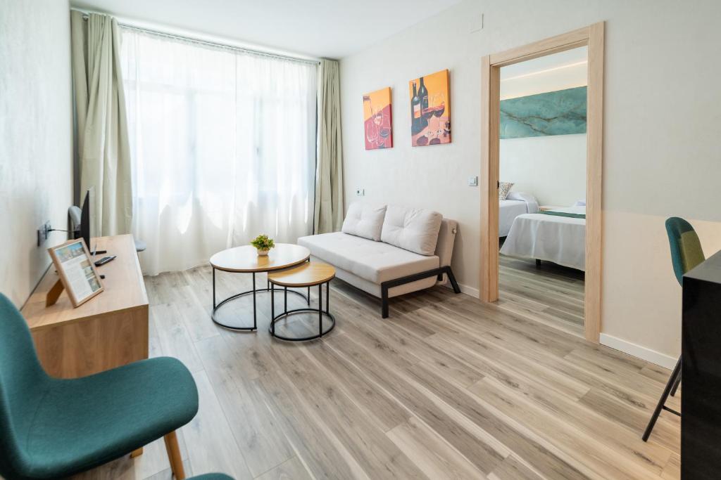 a living room with a couch and a table at Apartamentos El Real in Mota del Cuervo