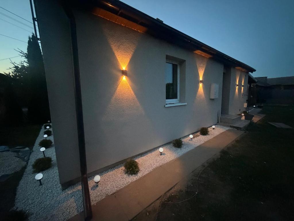 a building with lights on the side of it at Dom nad jeziorem Krasne in Krasne