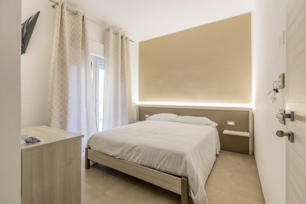 a small bedroom with a bed and a window at Nova Suite in Calatafimi