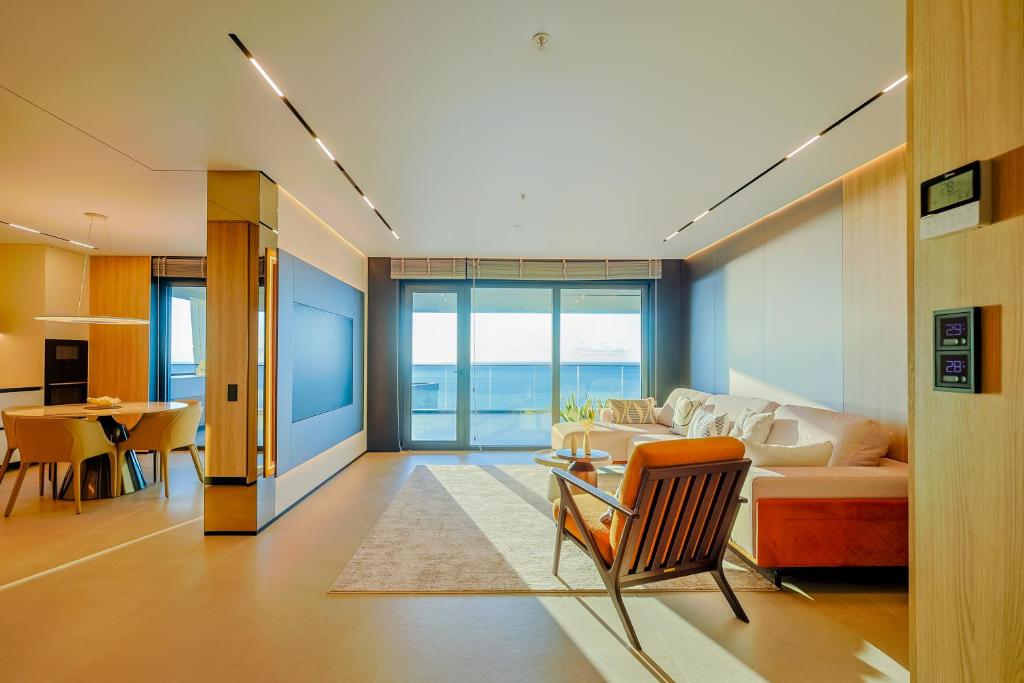 a living room with a couch and a table at OPUS Batumi in Batumi