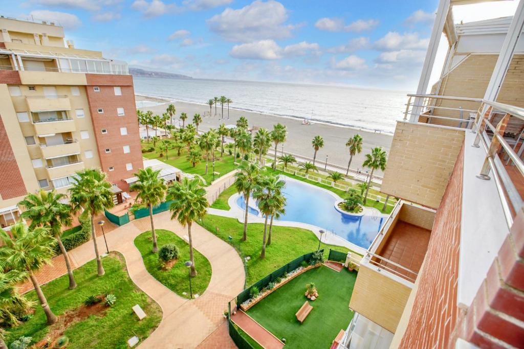 a view of the beach from the balcony of a building at Modern apartment in Roquetas de Mar with sea view in Roquetas de Mar