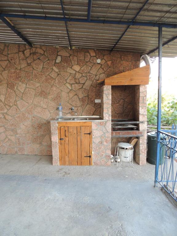 an outdoor kitchen with a counter and a stone wall at Sea View Apartment Ulcinj 80 m² in Ulcinj