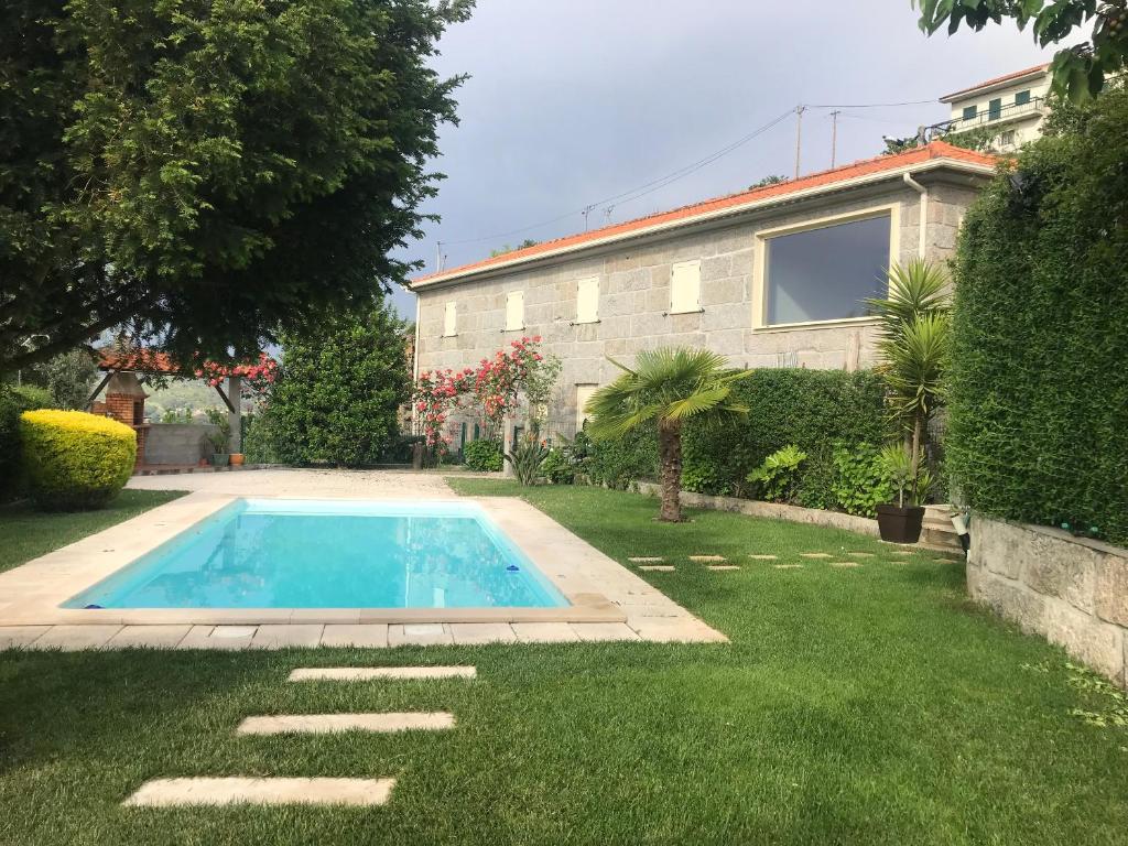 a swimming pool in the yard of a house at Charming Villa in Resende with Private Pool in Resende