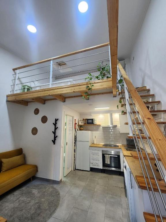 a kitchen with a spiral staircase in a room at Tiny House Faro in Faro