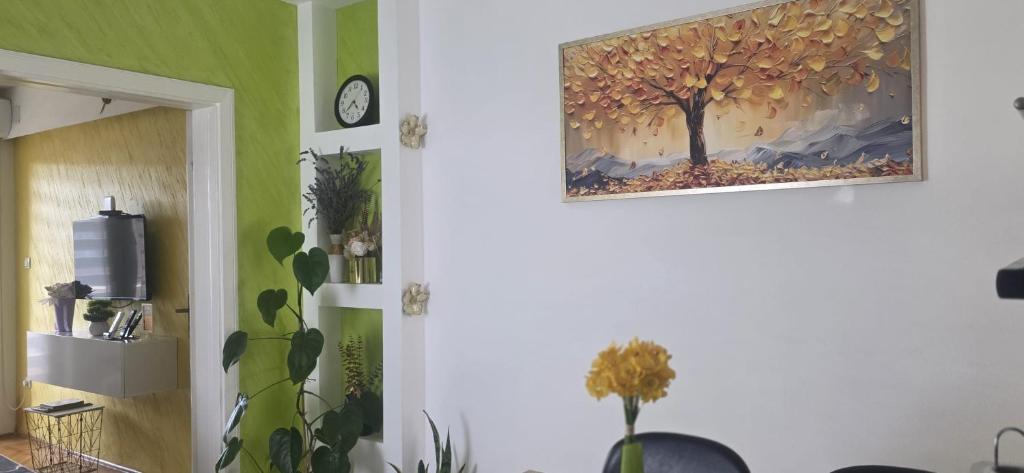 a wall with a painting of a tree on it at Fine Rest- City Center Apartment in Brčko