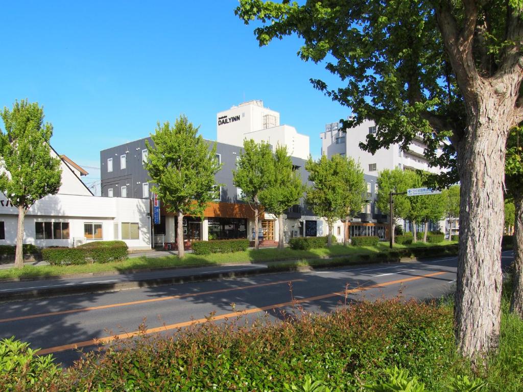 an empty street in a city with buildings at Tsukuba Daily Inn in Tsukuba