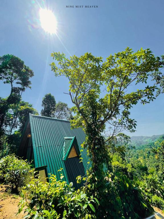 a green house in the middle of a forest at Nine Mist Heaven in Ella