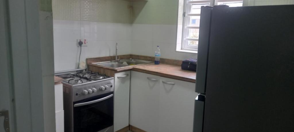 a kitchen with a stove and a sink at PAUL's PLACE in Loburo
