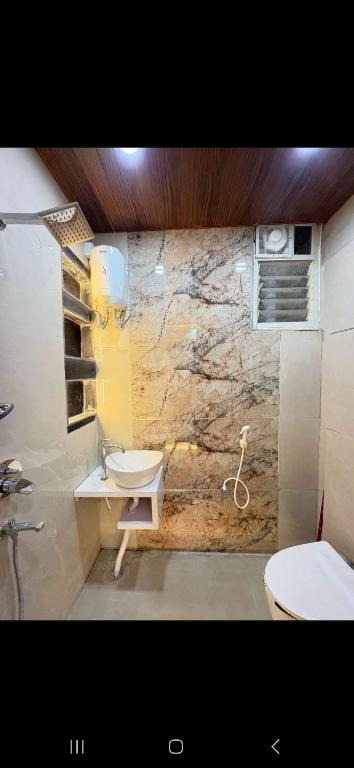 a bathroom with a sink and a toilet at Cube Stay in Bhopal