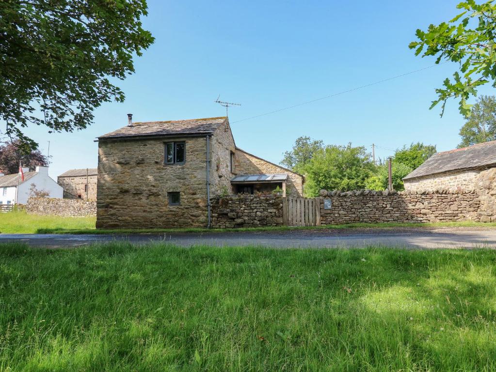 an old stone house on the side of a road at The Brew House in Penrith