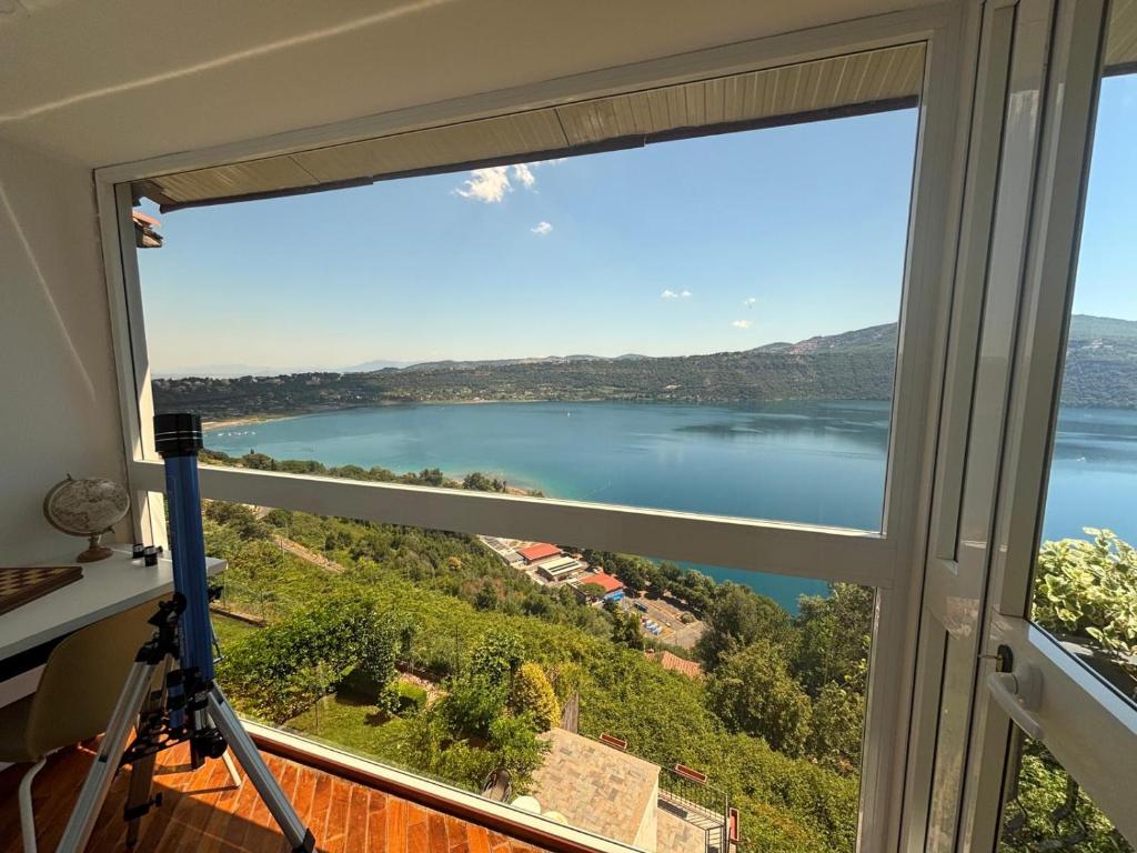a view of a lake from a window at la vista sul lago in Castel Gandolfo