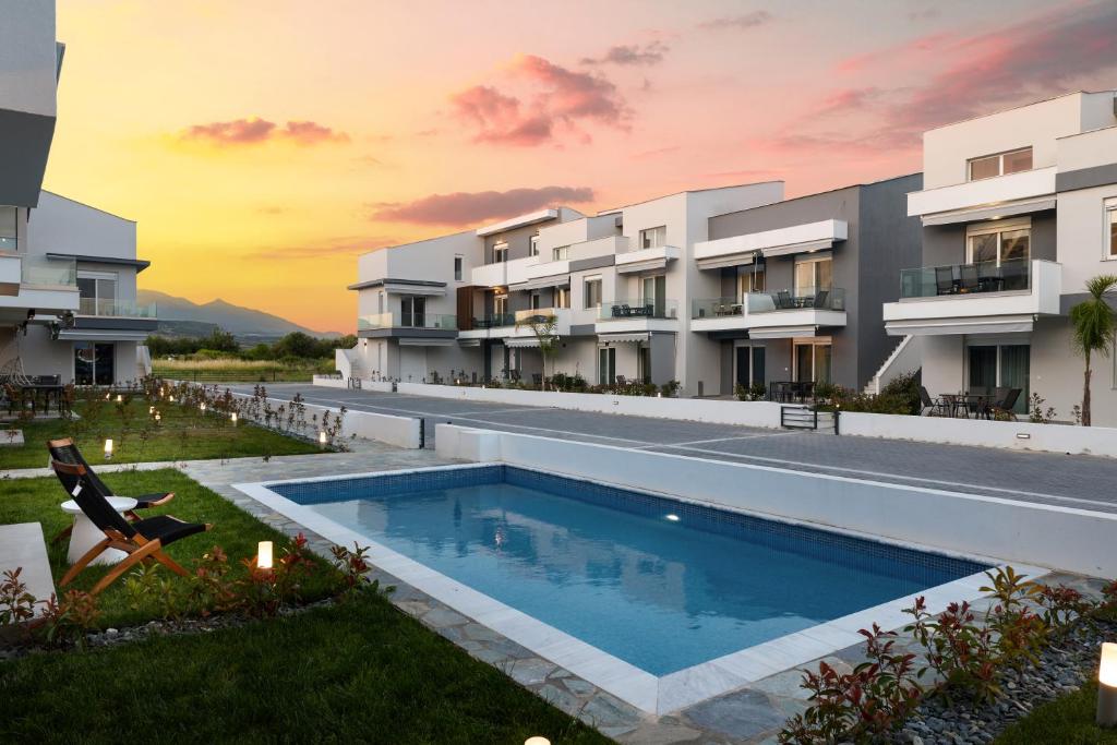 an exterior view of a resort with a swimming pool at Green Almond Residential Complex in Orfánion