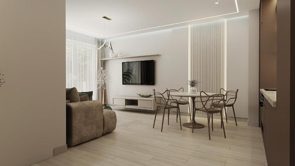 a living room with a table and chairs and a couch at Apartamenty Kościuszki Winda Klimatyzacja in Iława