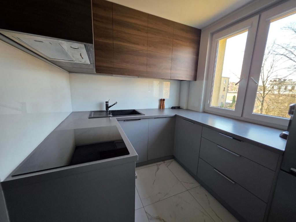 a kitchen with a sink and a counter top at Majowy in Siedlce
