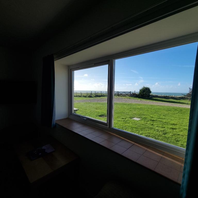 a window in a room with a view of a field at Oer in Llangian