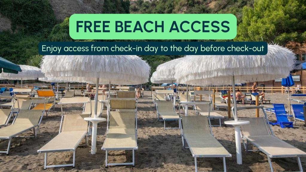 a group of beach chairs and umbrellas on a beach at Hotiday Vico Equense in Vico Equense