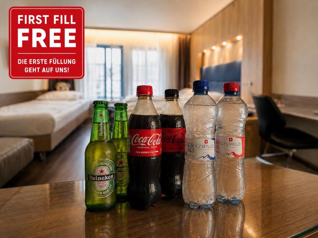 a group of soda bottles sitting on a table at Hotel Alexander Zurich Old Town in Zurich