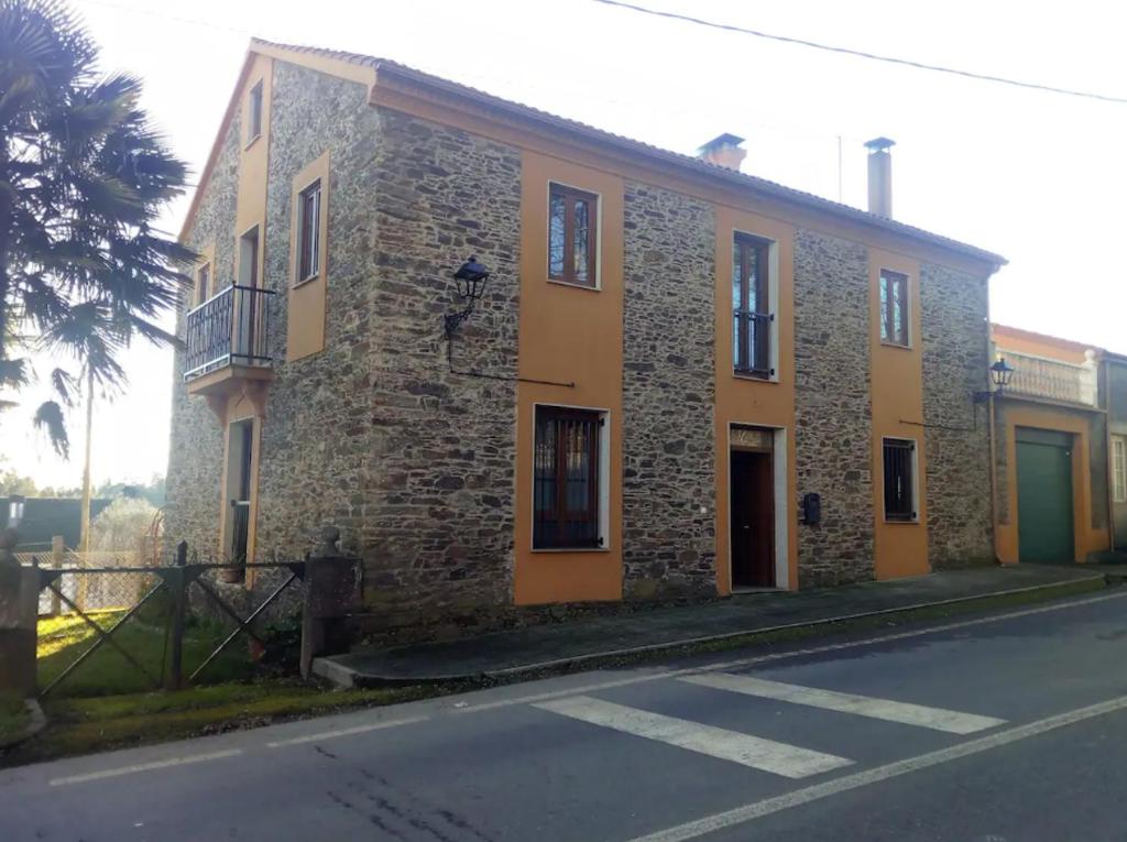 a brick building on the side of a street at Spacious villa with pool in Empalme de Vilar - 300 m², 8 guests in Vilar