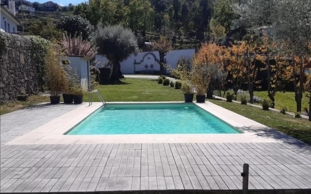a swimming pool in the middle of a garden at Beautiful villa in Póvoa de Lanhoso with pool and garden in Póvoa de Lanhoso
