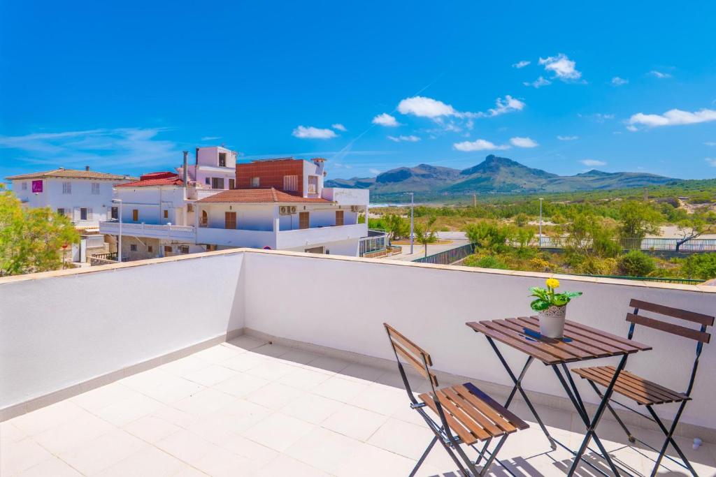 a patio with two chairs and a table on a balcony at Can Fusteret in Son Serra de Marina