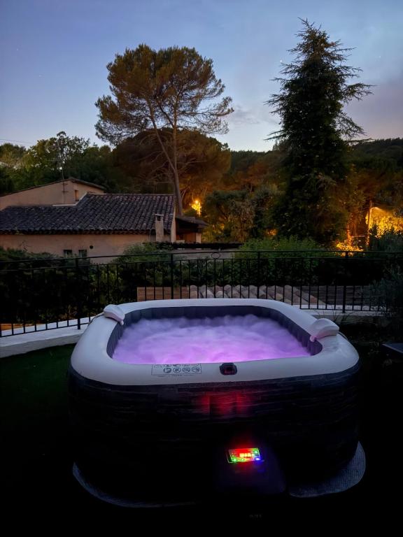 a large tub filled with purple liquid in a yard at Premium Apartment with Private Jacuzzi in Mougins
