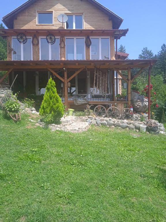 a large house with a wrap around porch at Spacious and Charming House in Vozuća with Large Garden in Vozuća