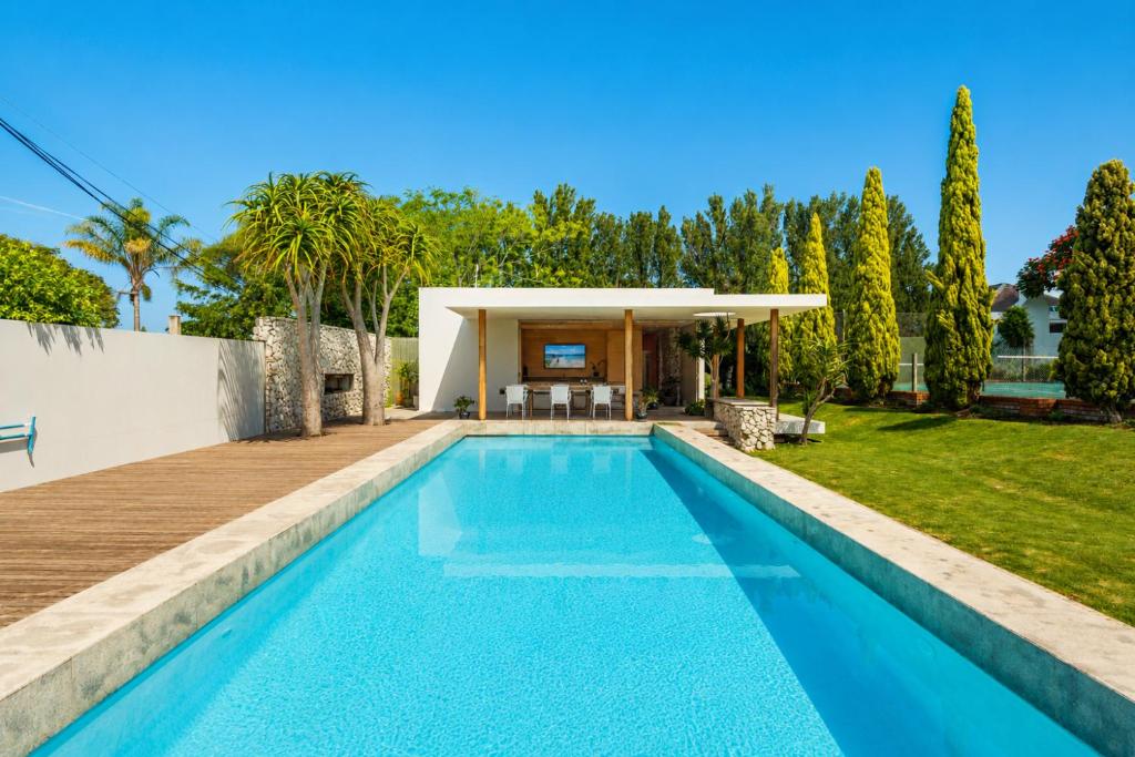 a swimming pool in the backyard of a house at The Pool House in Gqeberha