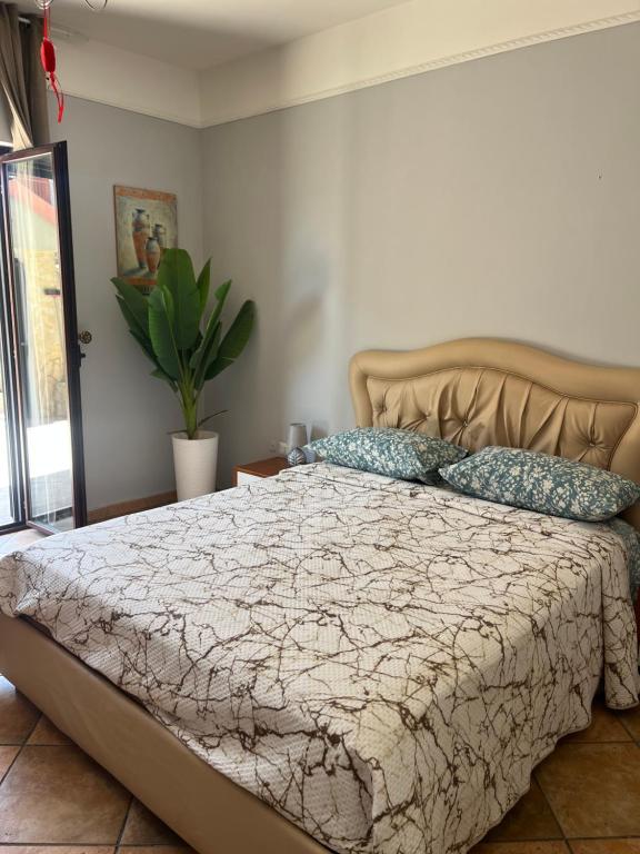 a bedroom with a large bed with blue pillows at Bed and Breakfast Medaglia D'oro in Marcianise