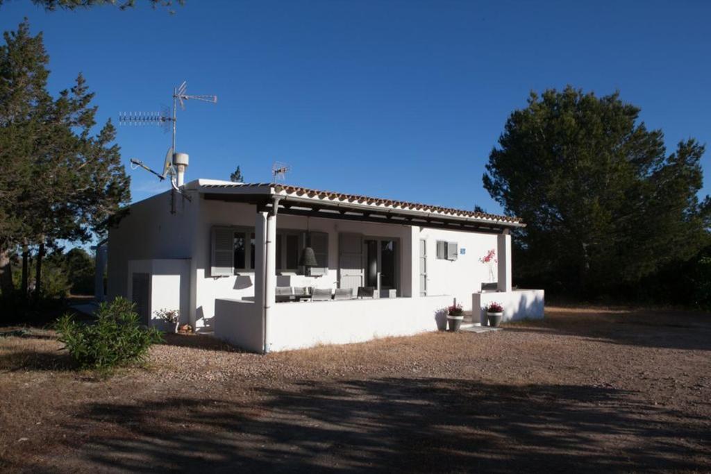 a small white house sitting on top of a yard at Comfortable House in Formentera with Garden and Terrace in Sant Francesc Xavier