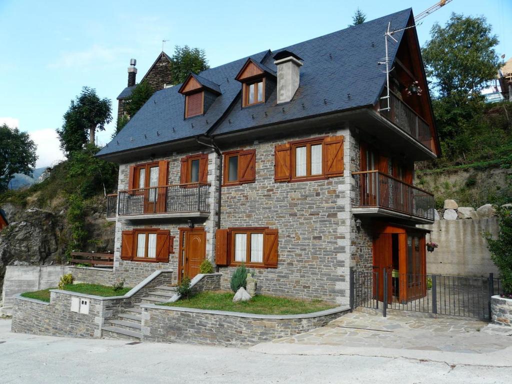 a large brick house with a black roof at Charming Chalet in Viella, Mountain View in Vielha