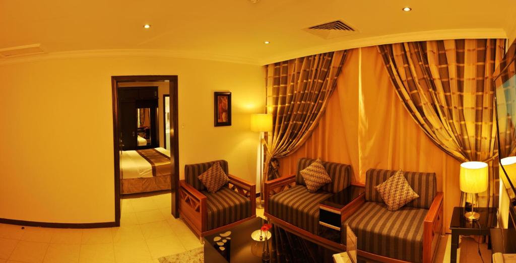 a hotel room with a couch and a bed at Nelover Al Khobar in Al Khobar